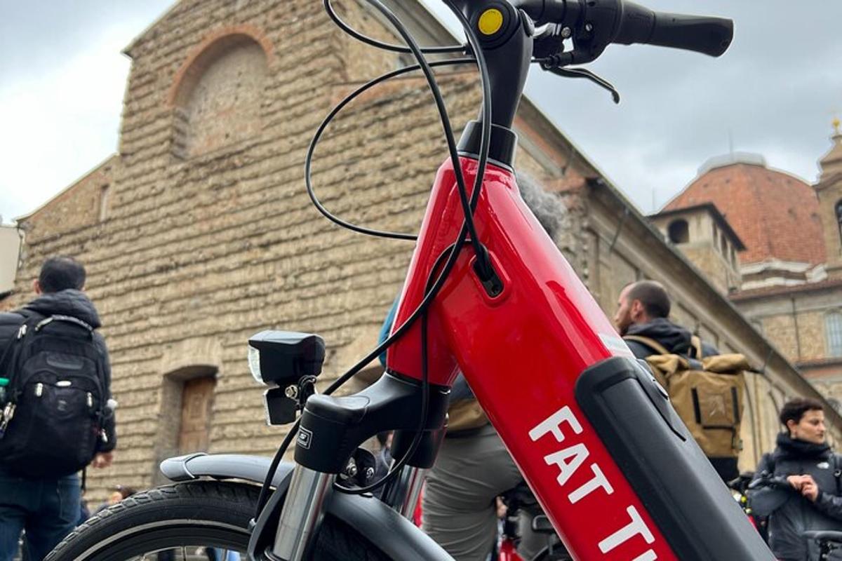a red motorcycle parked in front of a building