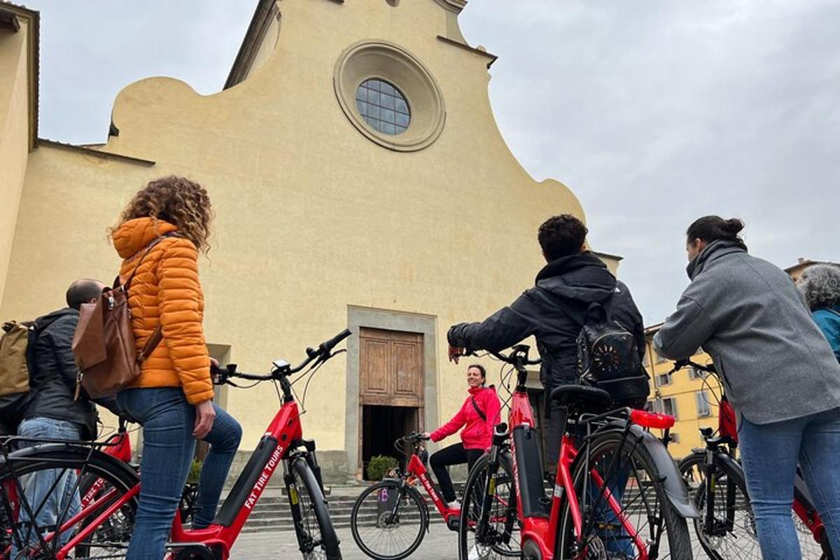 a group of people on bikes in front of a church