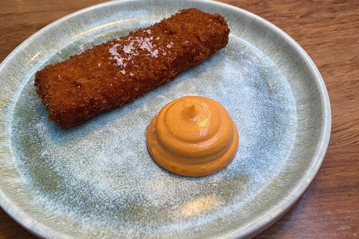 a plate with a piece of food and a sauce