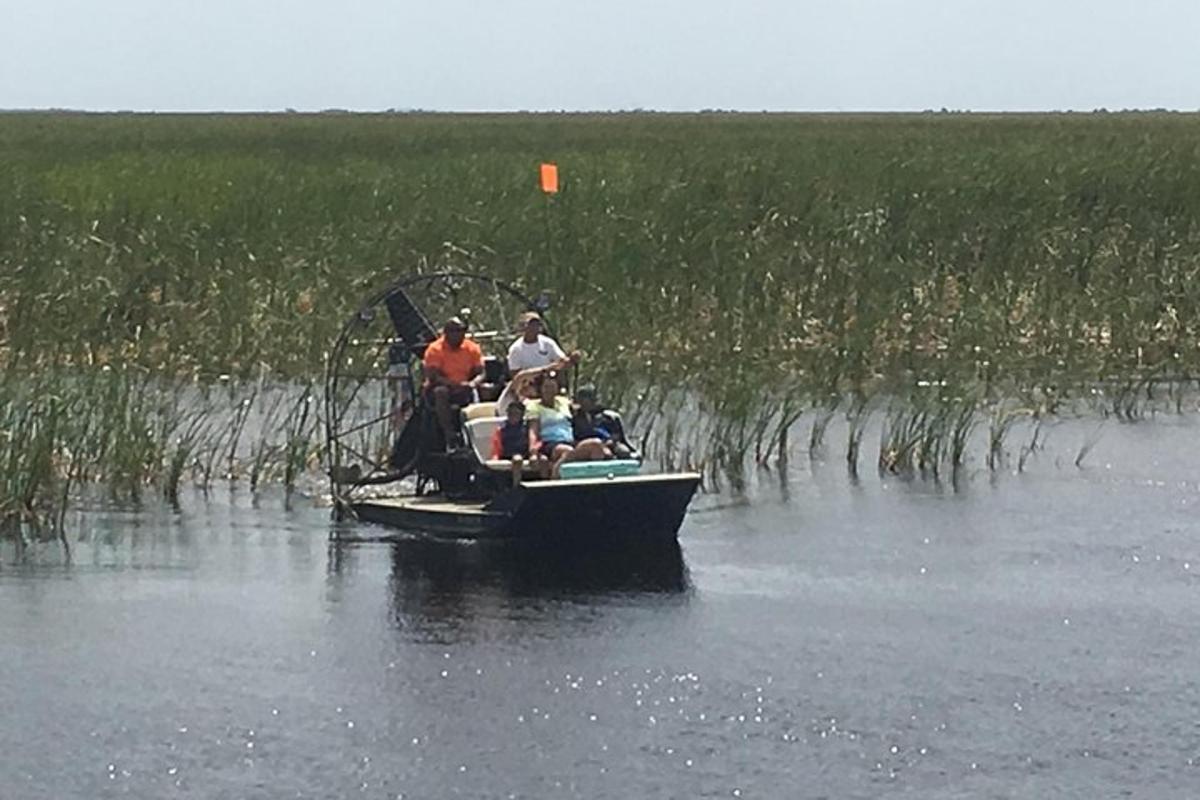 a group of people in a boat on a body of water