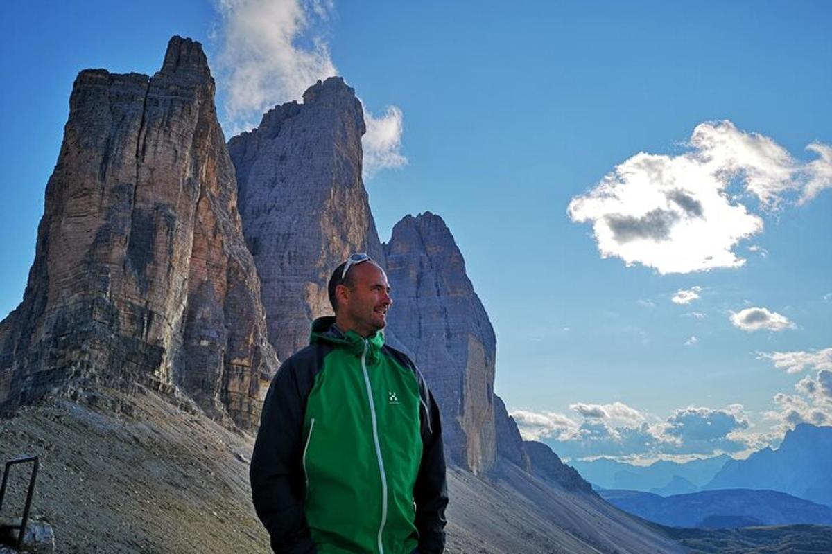 a man is standing in front of a mountain