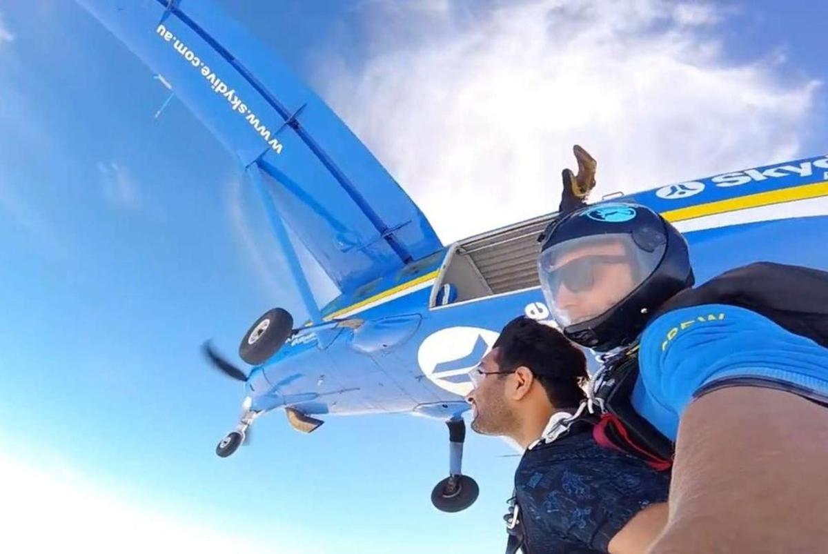 a man standing in front of a small airplane