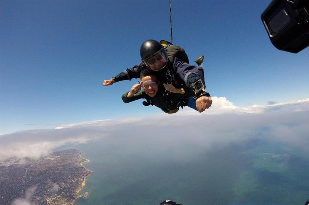 a man hanging from a rope in the sky