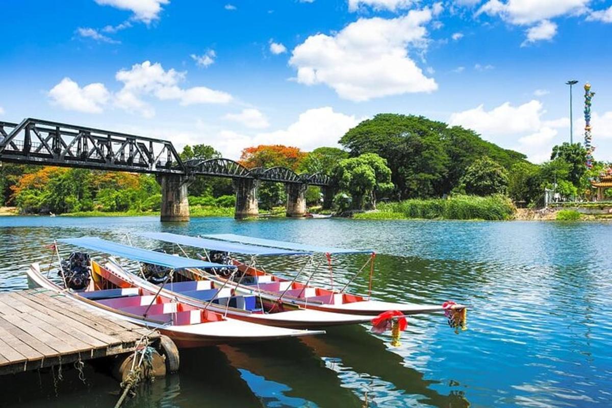 a boat is docked next to a bridge on a river