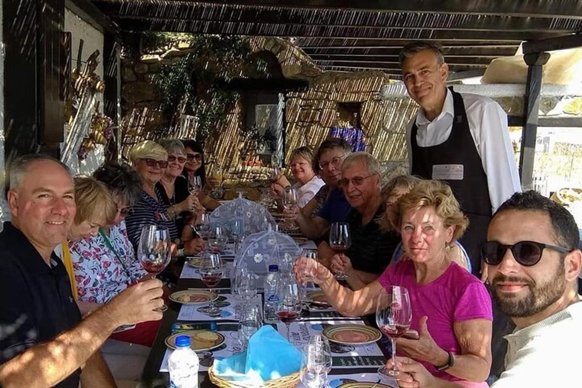 a group of people sitting around a table with wine glasses