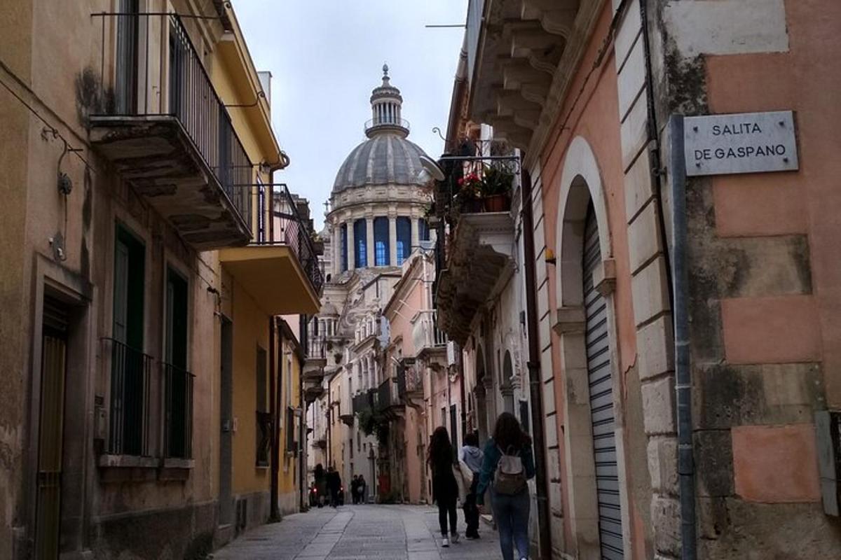 a group of people walking down a street with a building