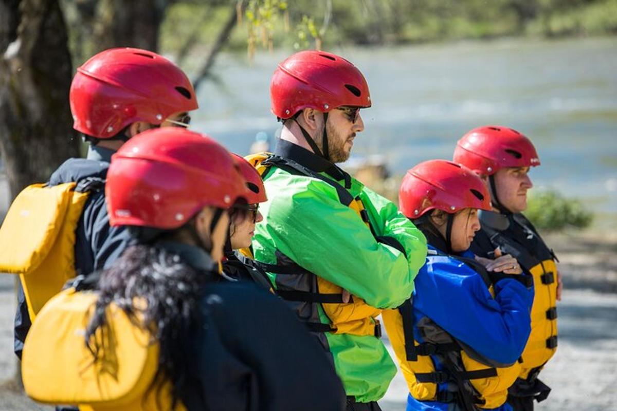 a group of people wearing life jackets and helmets