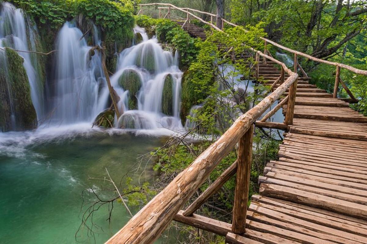 a staircase leading to a waterfall next to a river
