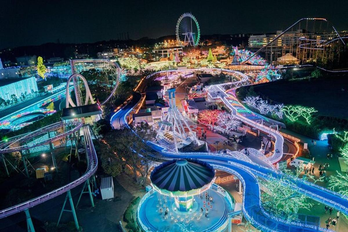 an amusement park at night with a roller coaster