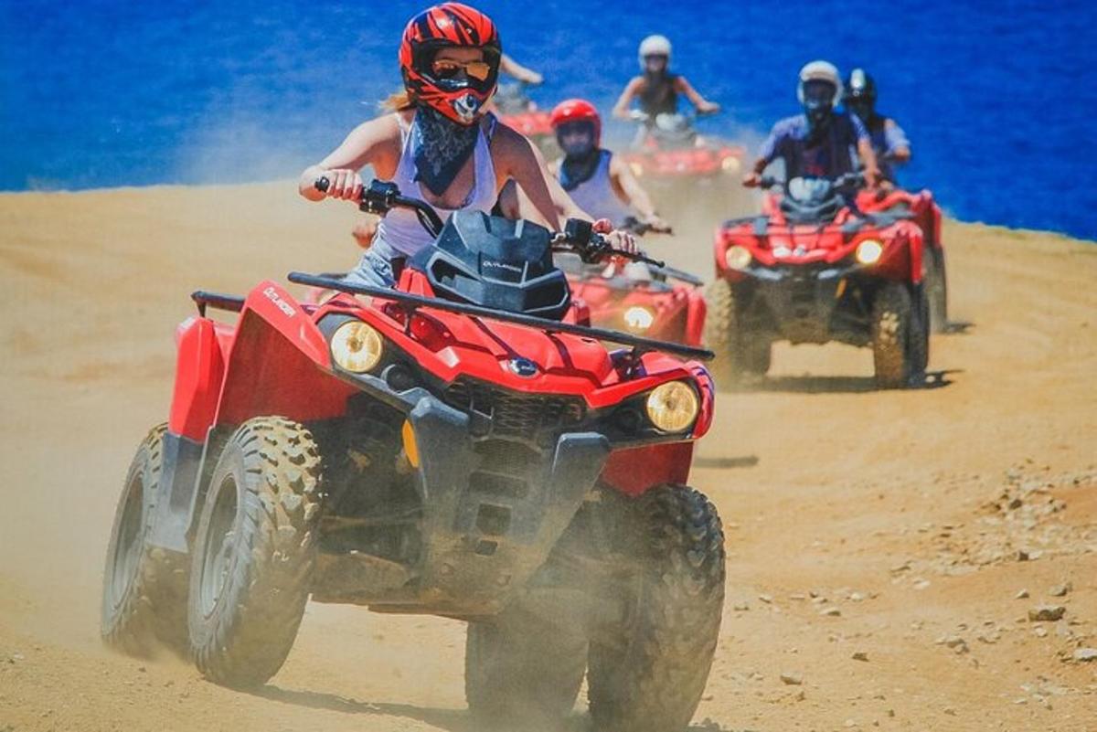 sekumpulan orang menunggang atv di pantai