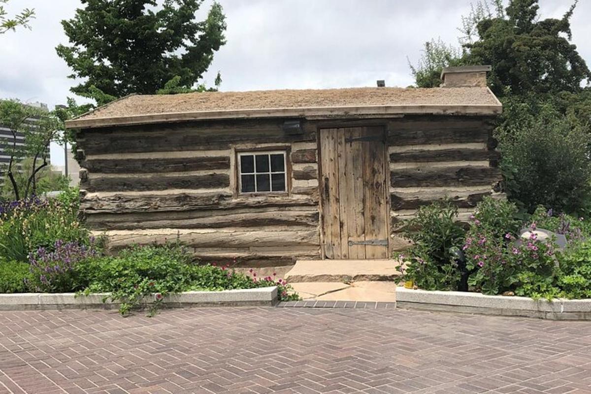 a wooden cabin with a door in a garden
