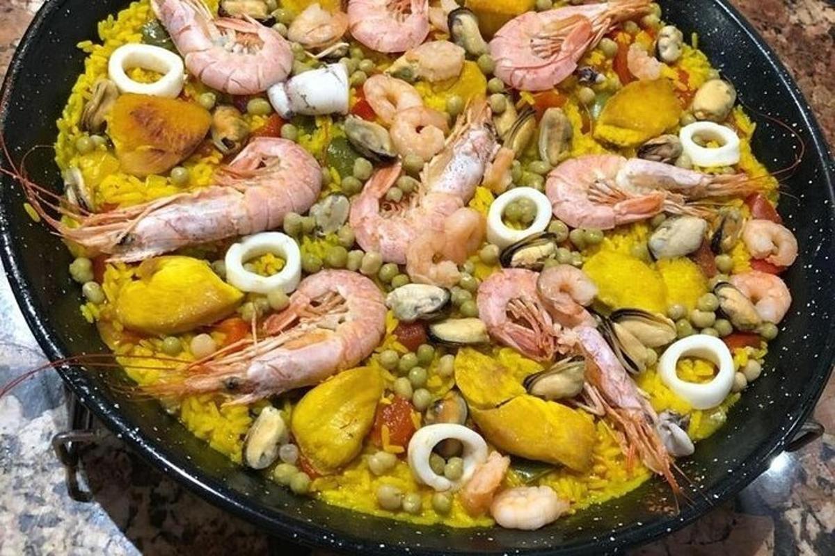 a pan filled with shrimp and vegetables on a table