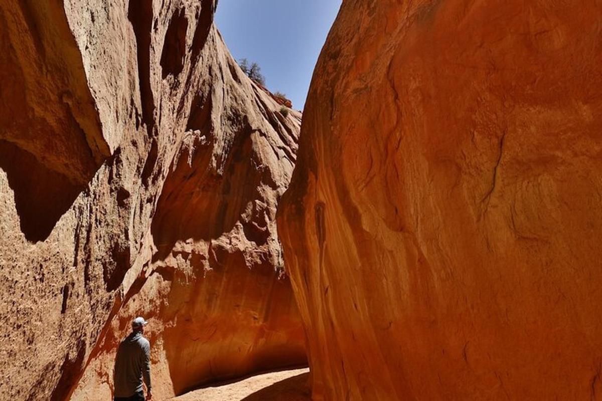 a man walking through a slot canyon