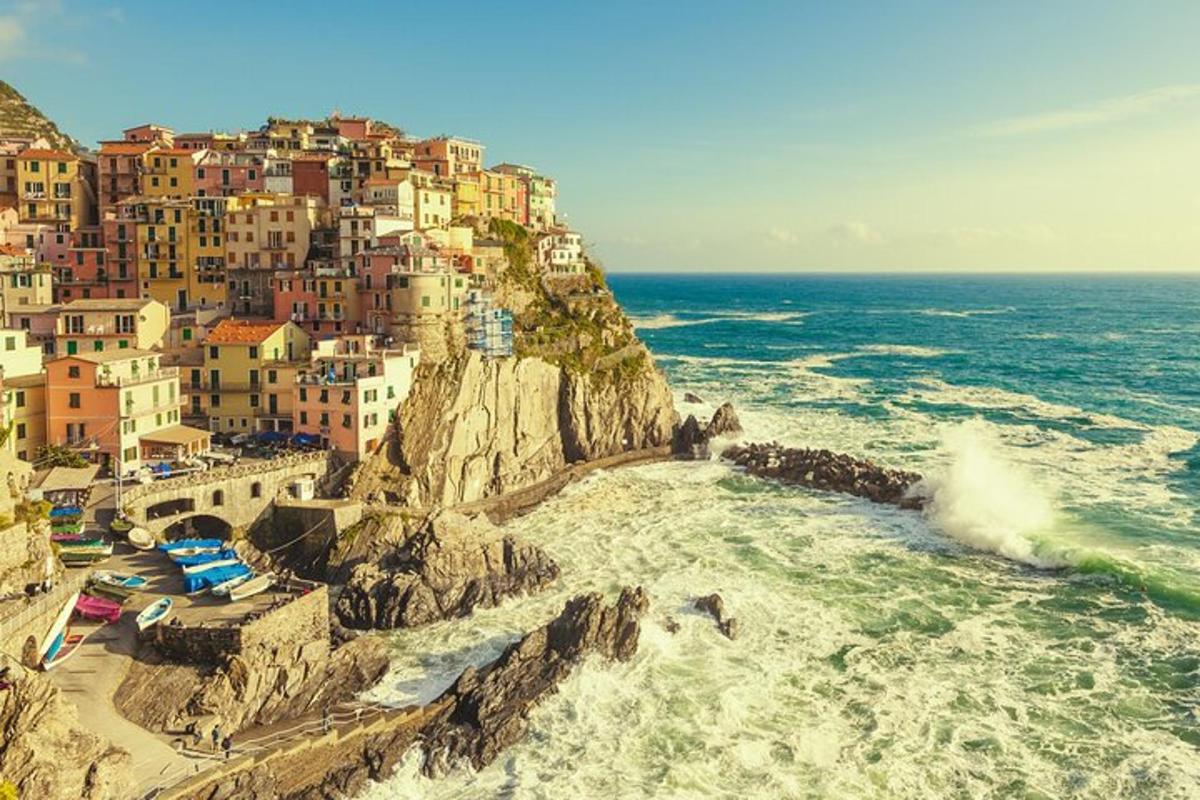 a town on top of a mountain next to the ocean