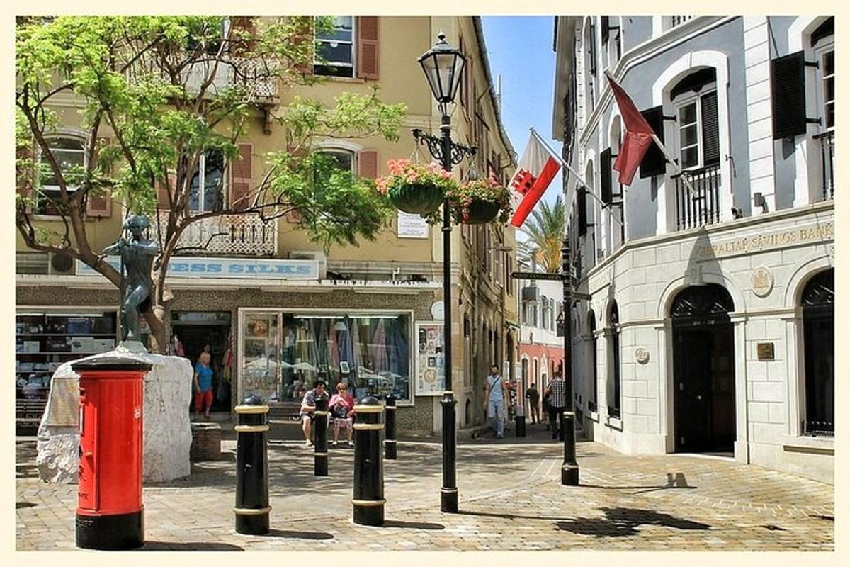 a street with a red fire hydrant in front of a building