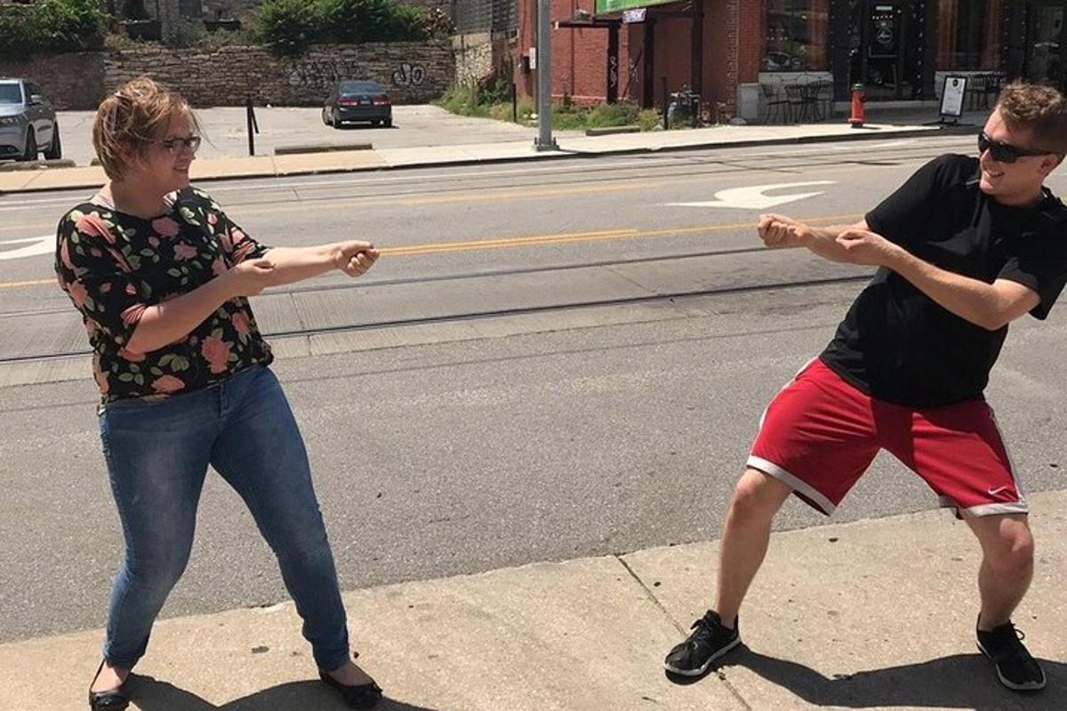 two people playing with a frisbee on the street