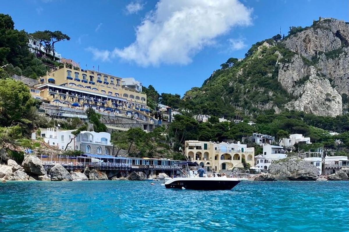 a boat in the water in front of a mountain
