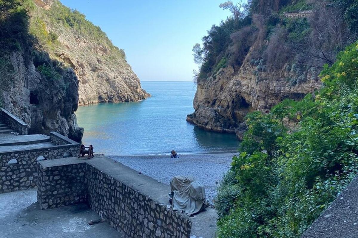 a view of a beach with the ocean and cliffs