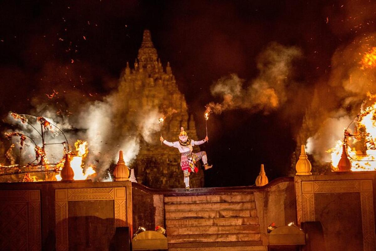 a man standing on a stage in front of fire