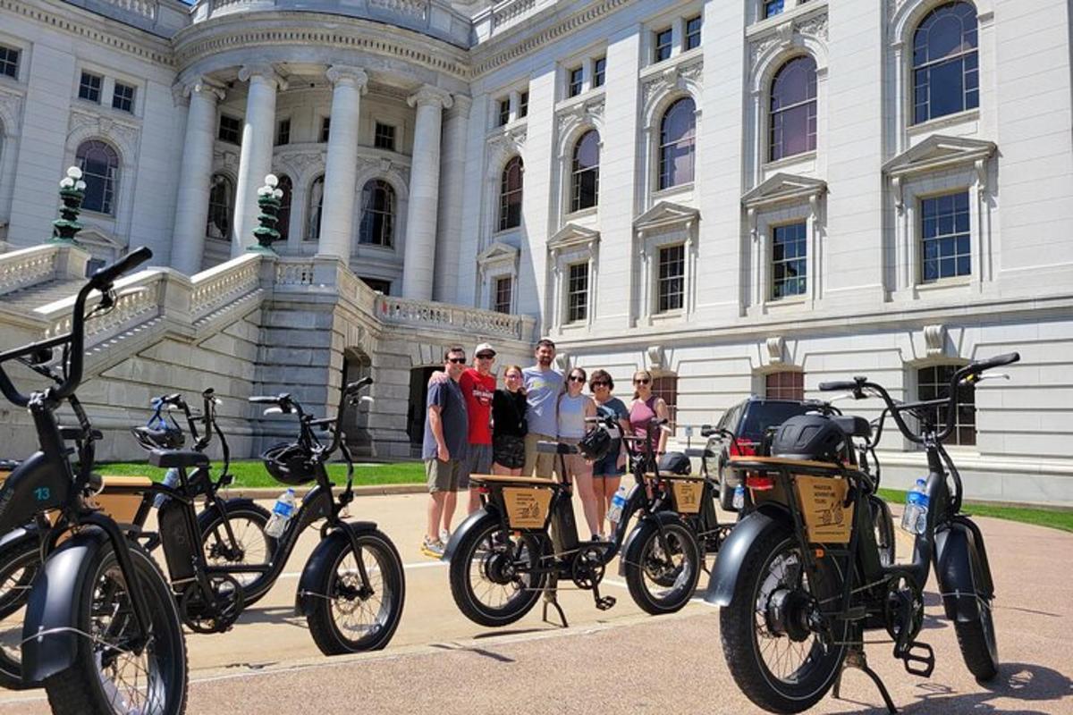 a group of people standing in front of a building with bikes