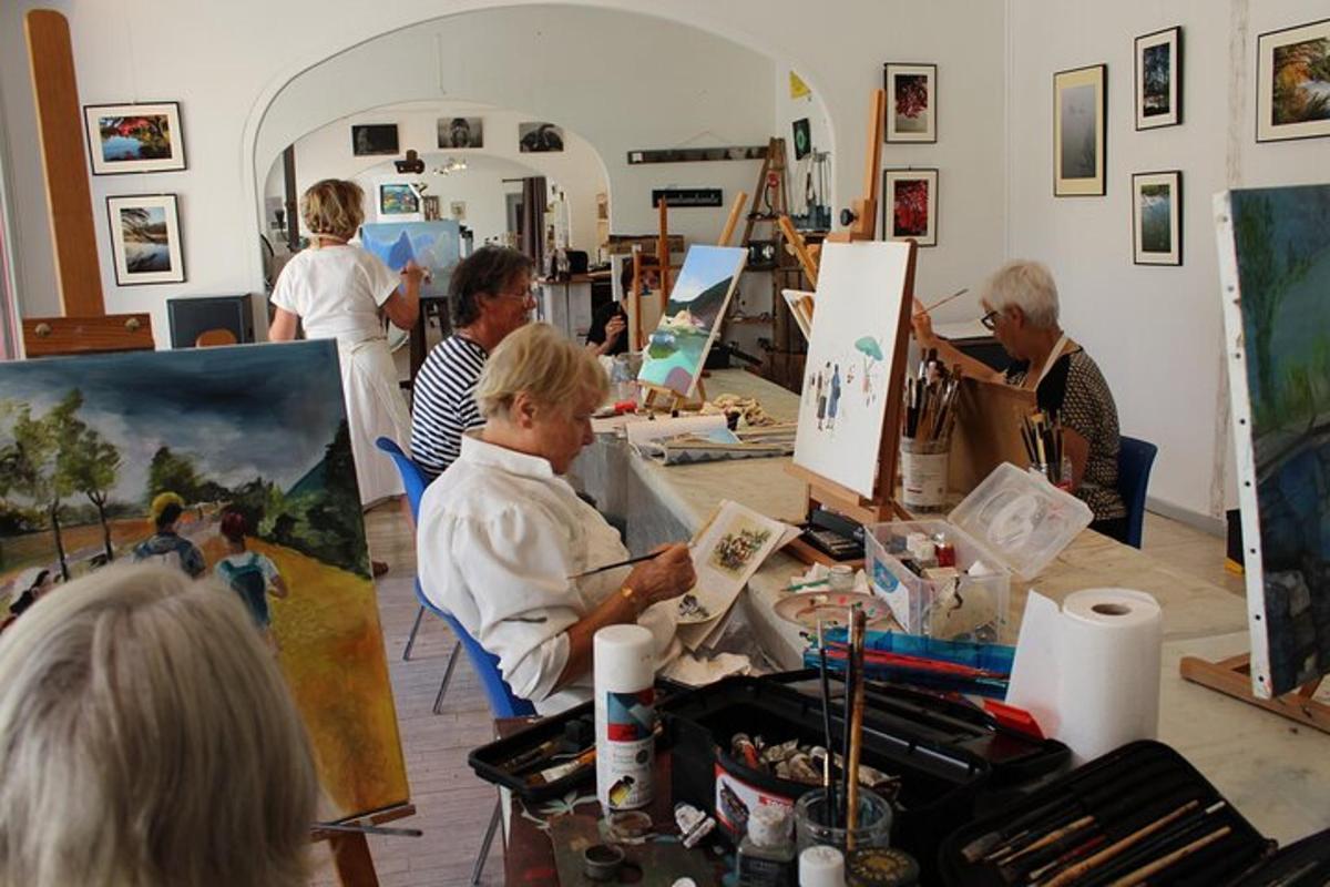 a group of people painting in an art room