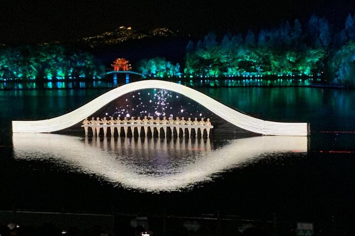 a white bridge over a body of water at night