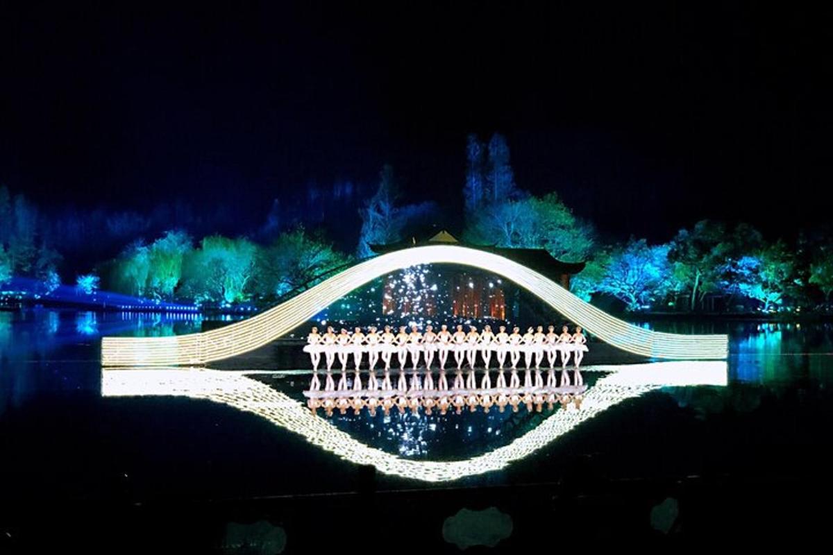 a bridge with lights on the water at night