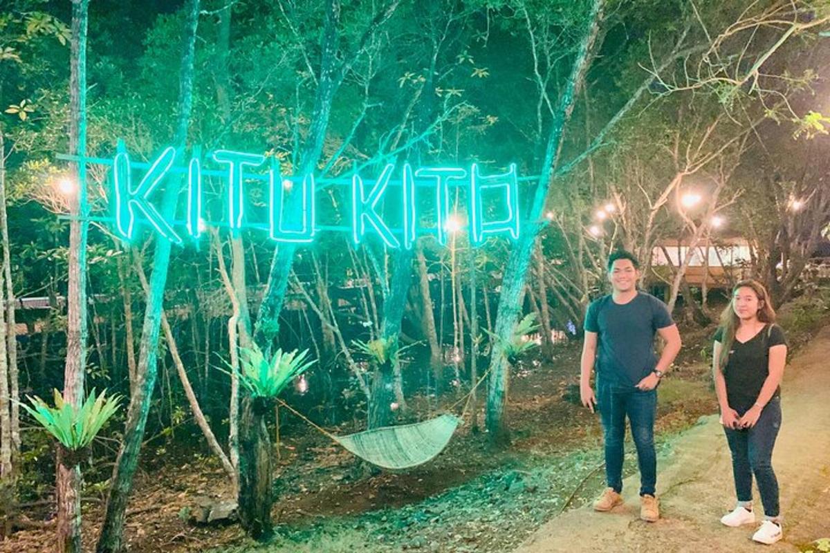 a man and a woman standing in front of a sign