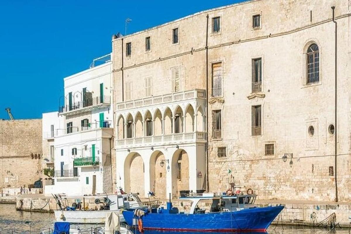 a blue boat in front of a large building