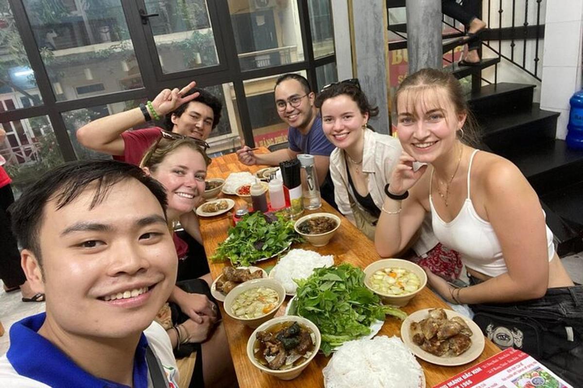 a group of people sitting at a table with food