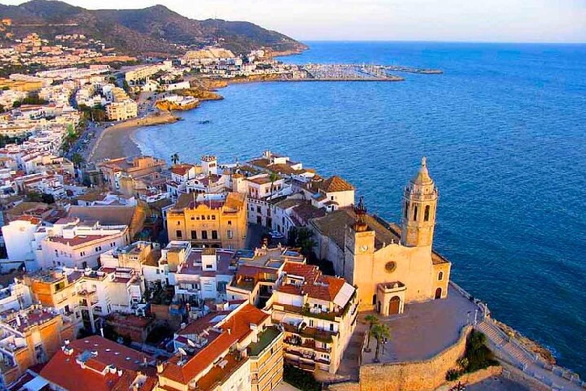 an aerial view of a town next to the ocean