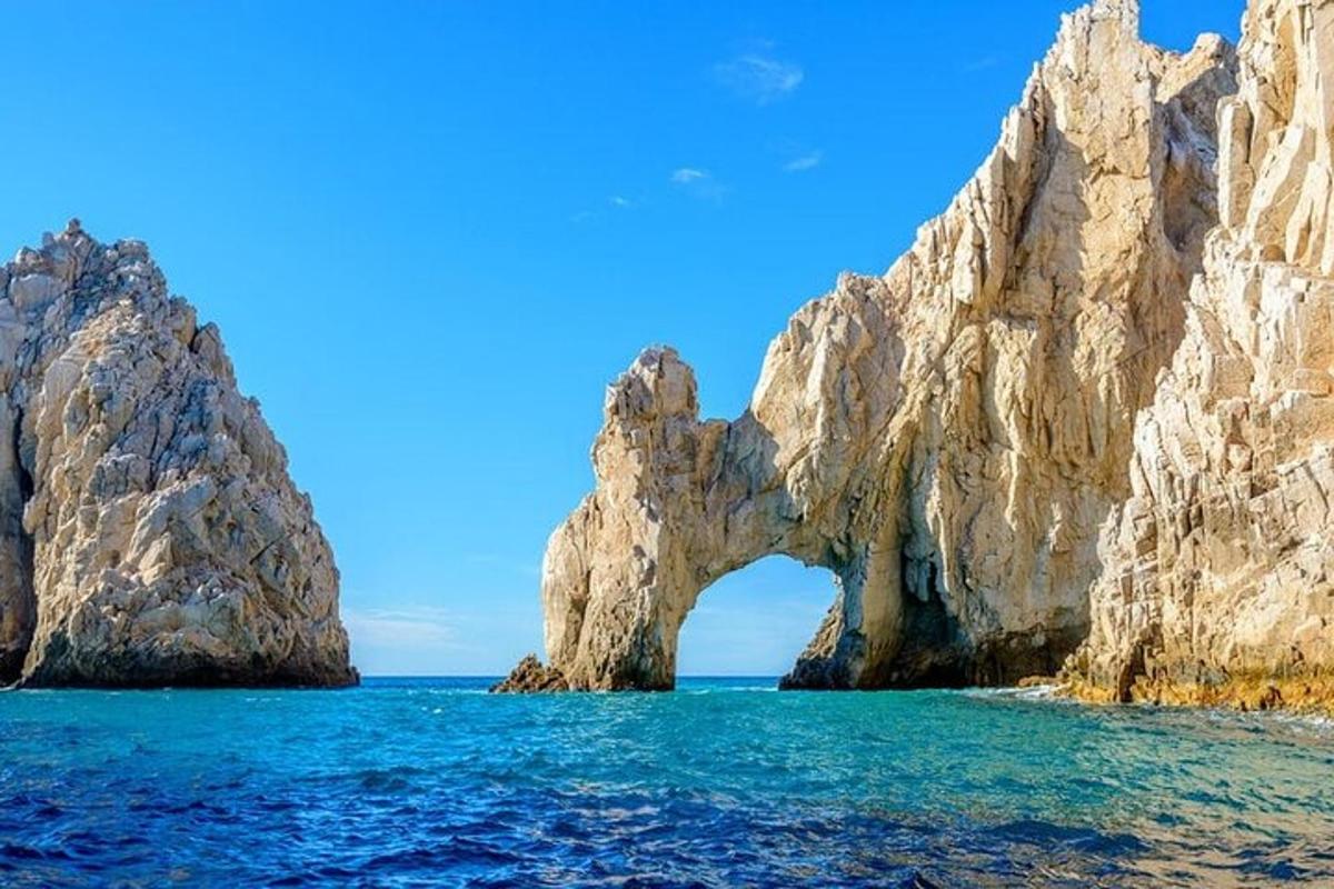 an arch in the rocks in the ocean