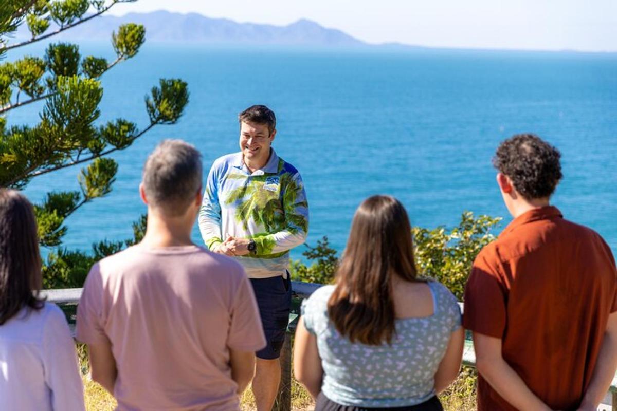 a group of people standing in front of the ocean