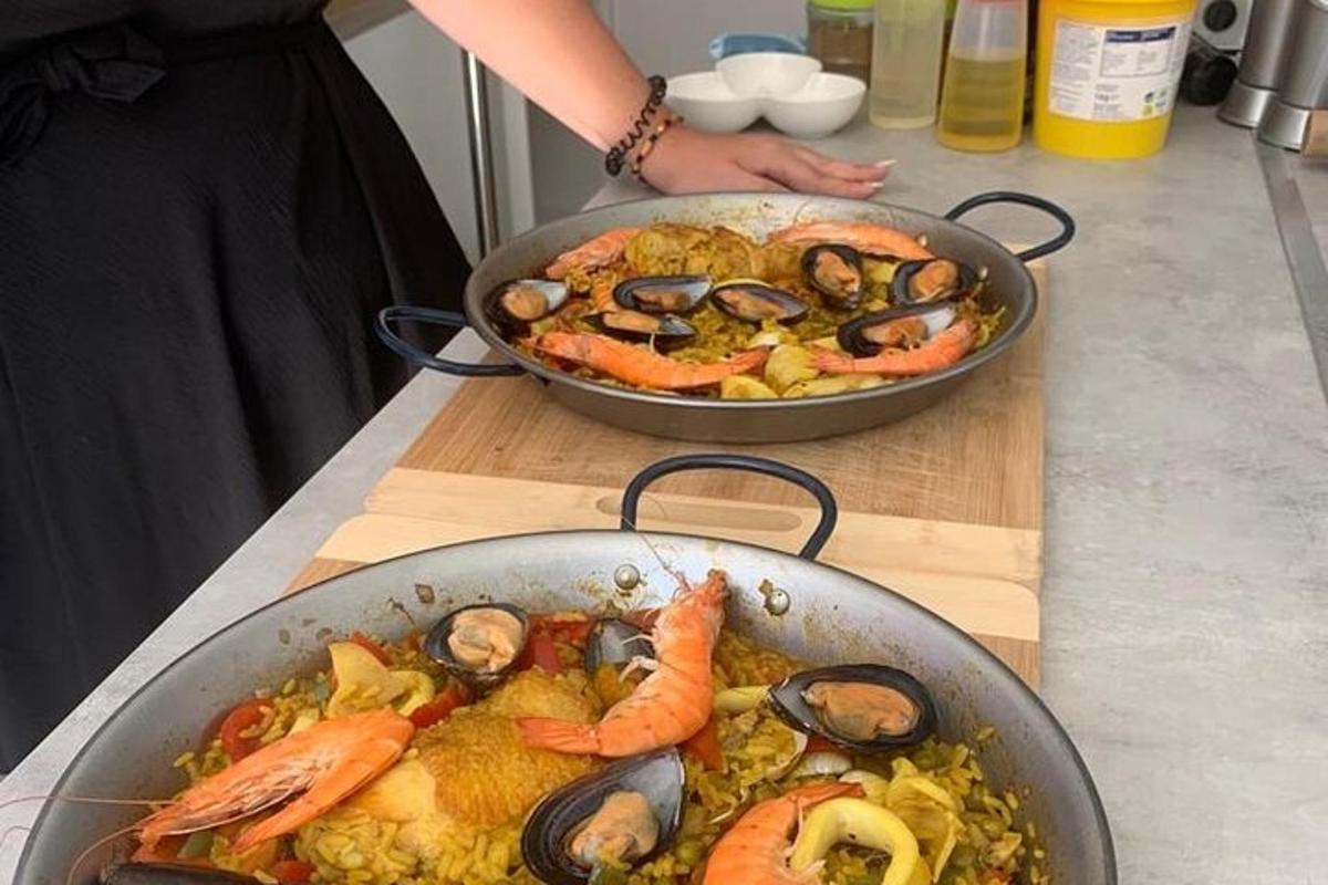 two pans of food on a counter with seafood