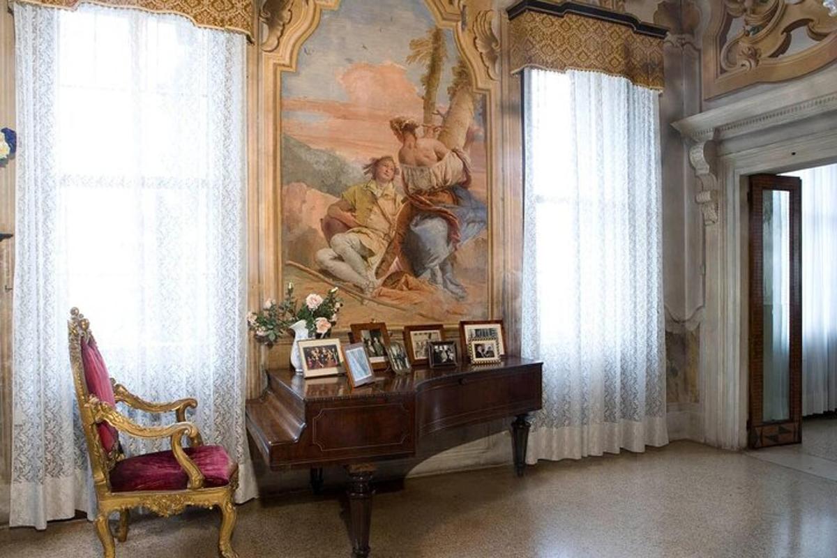 a piano in a room with a painting on the wall