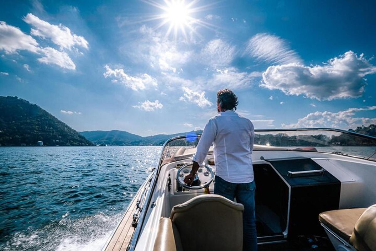 a man standing on the front of a boat on the water