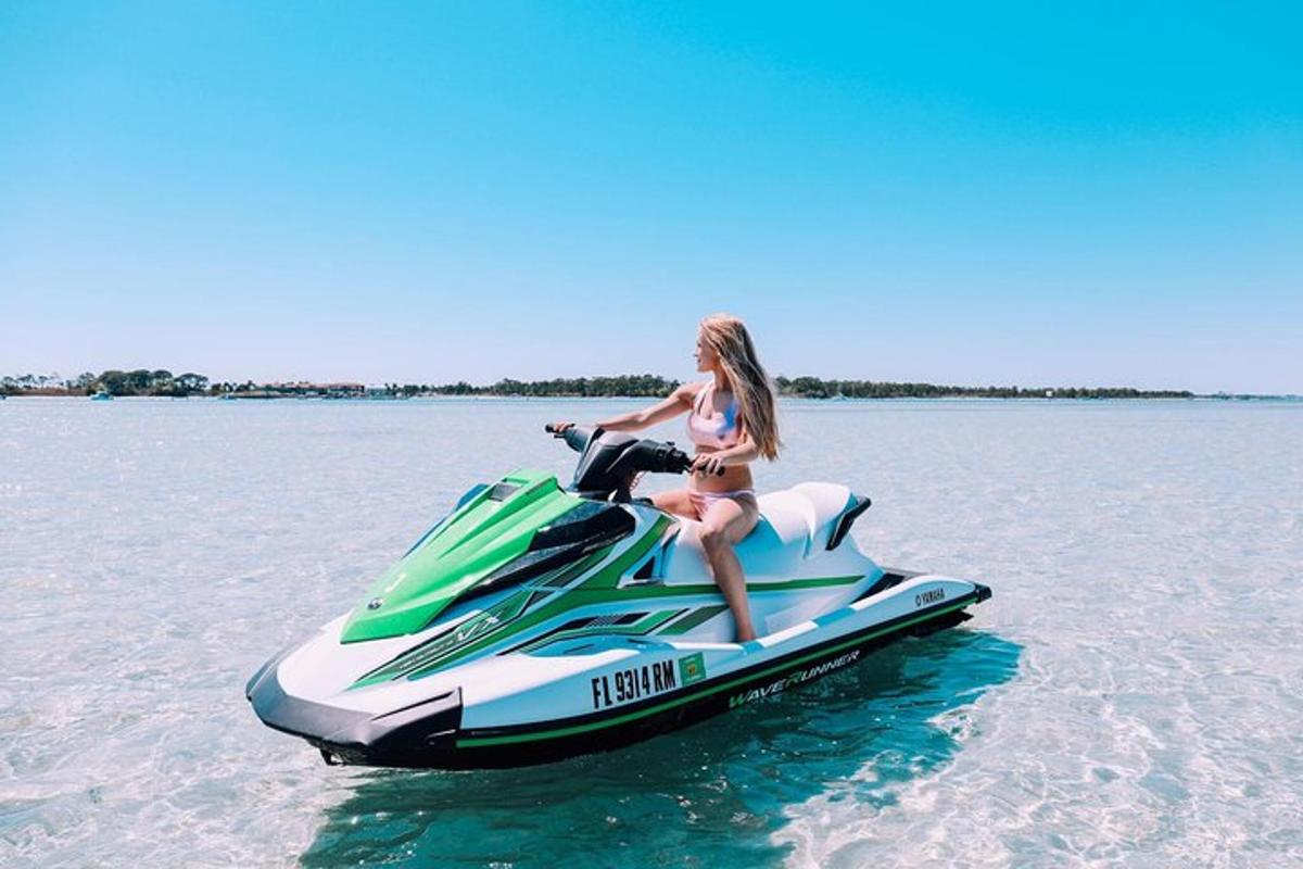 a girl sitting on a jet ski in the water