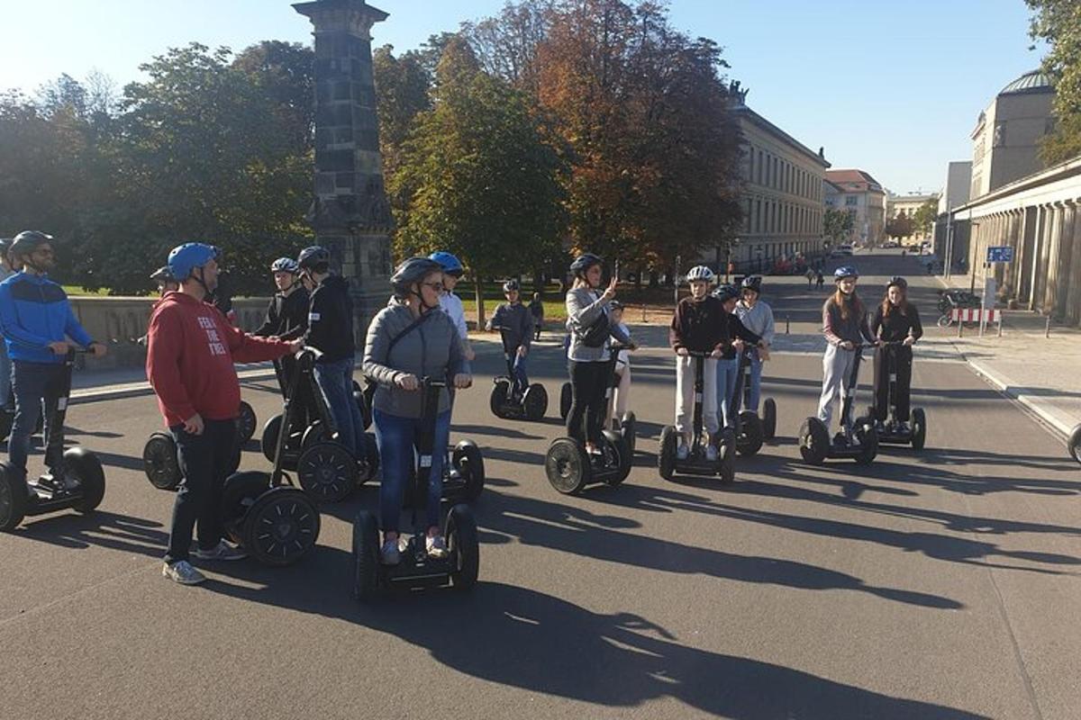 a group of people riding on segways down a street