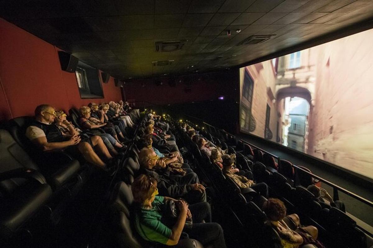 a group of people sitting in an audience in an auditorium
