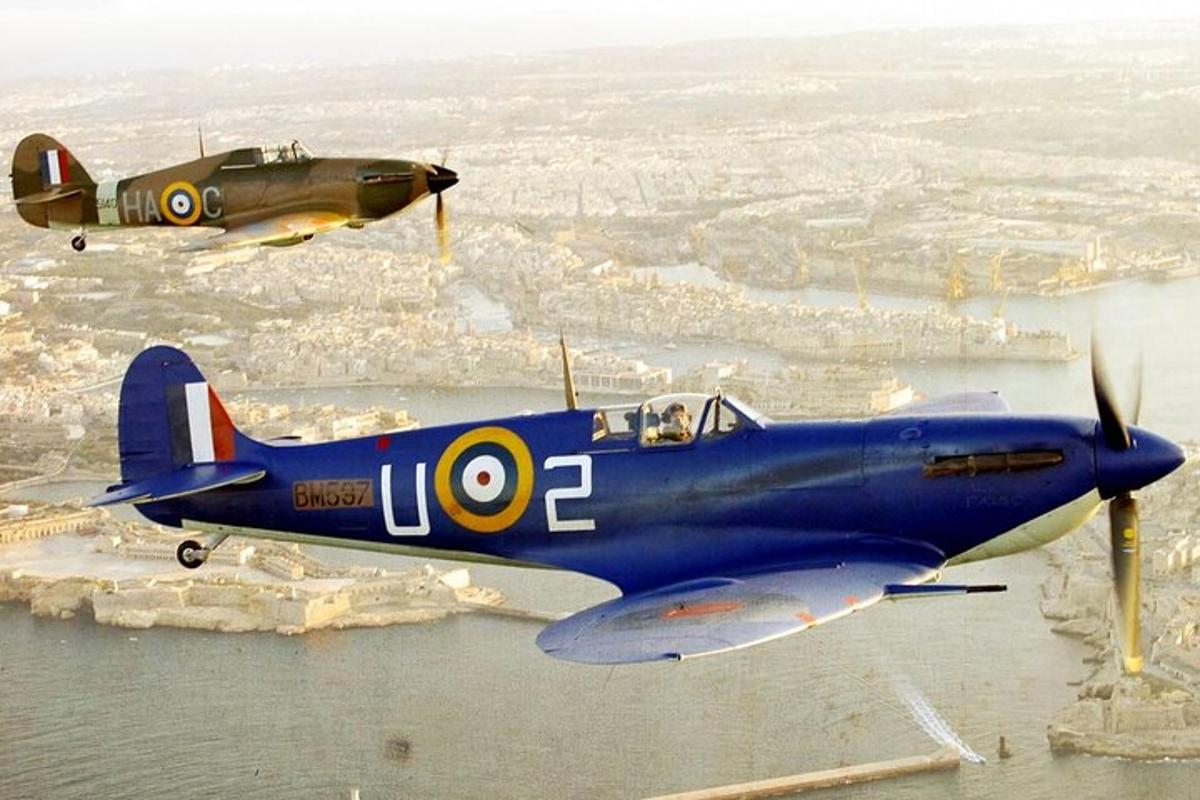 two old planes are flying in the air