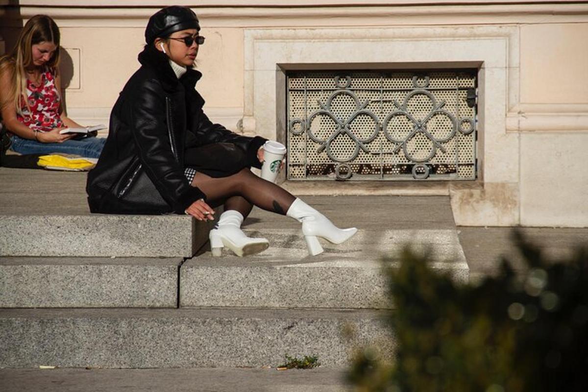 a woman sitting on steps with a cup of coffee