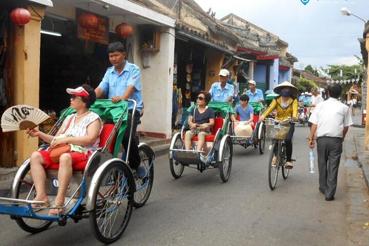 a group of people riding in rickshaws down a street