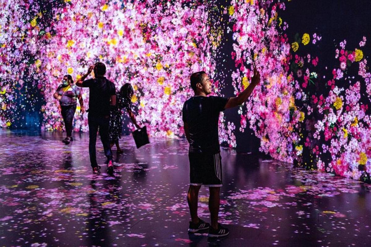 a group of people standing in front of a colorful exhibit
