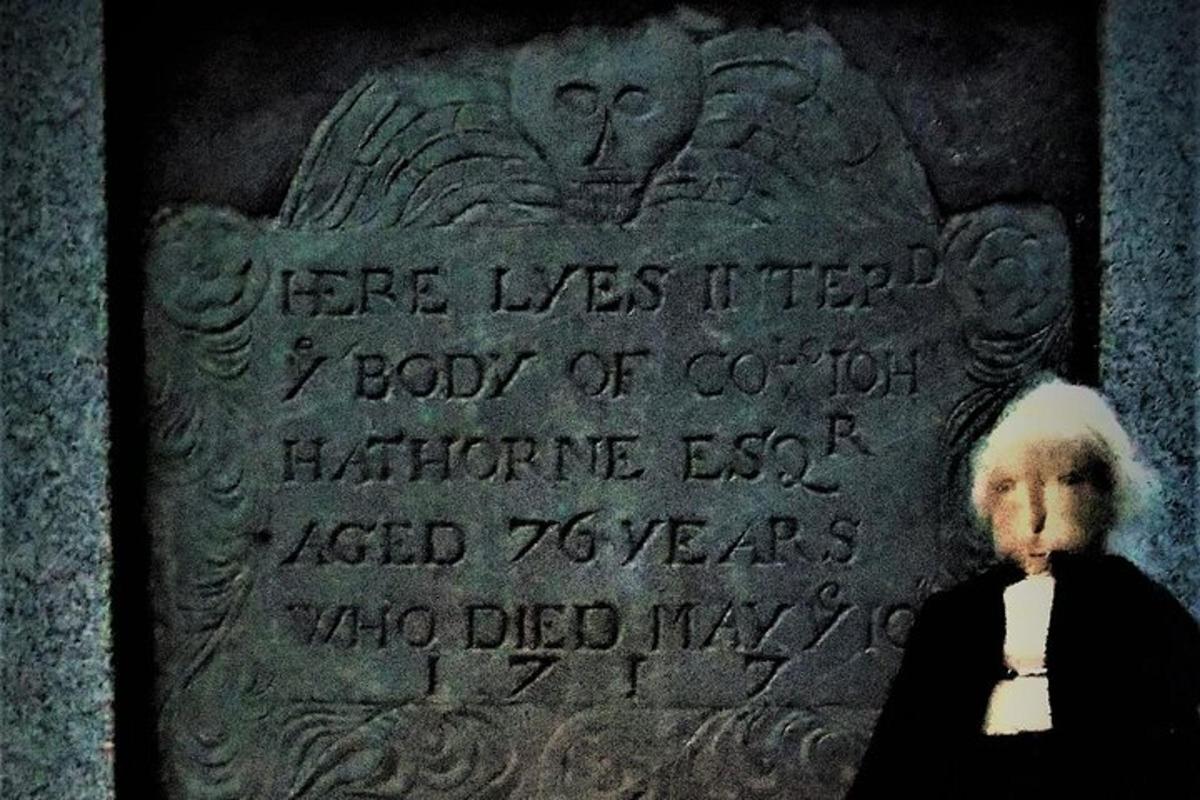a person standing in front of a stone monument