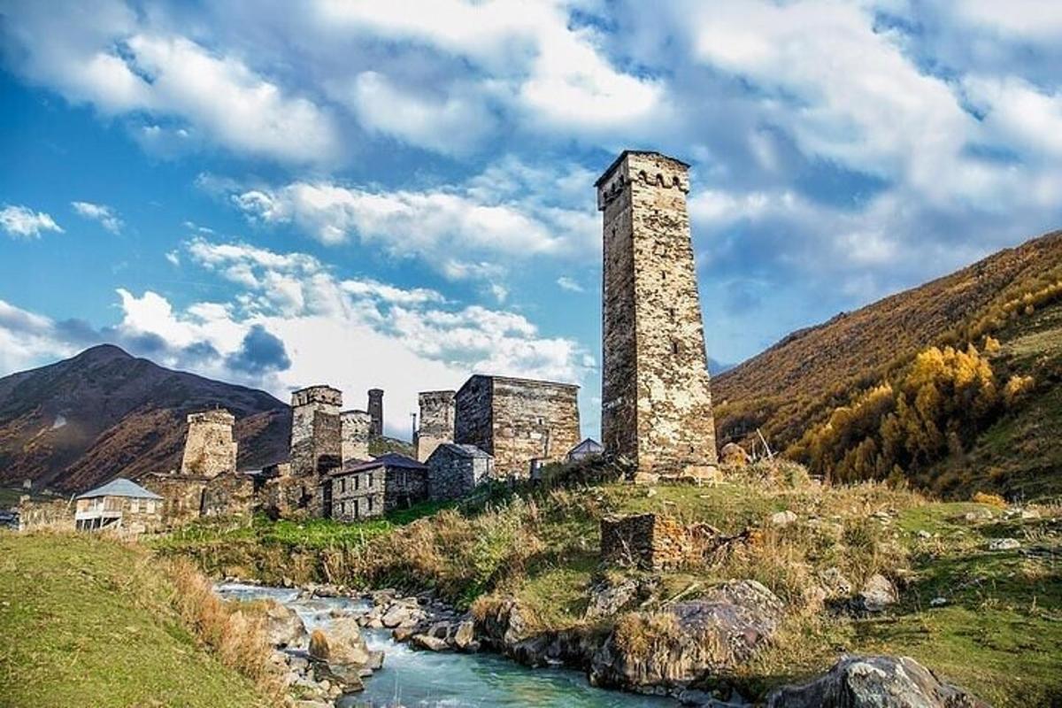 an old castle on a hill next to a river