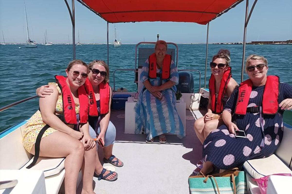 un grupo de personas sentadas en la parte trasera de un barco