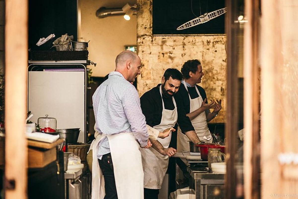 a group of men in a kitchen preparing food