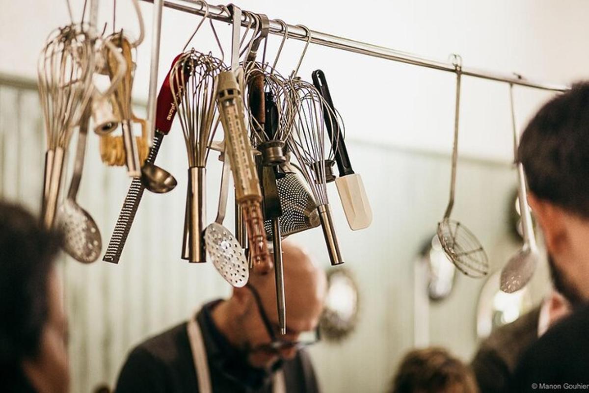 a group of kitchen utensils hanging on a wall
