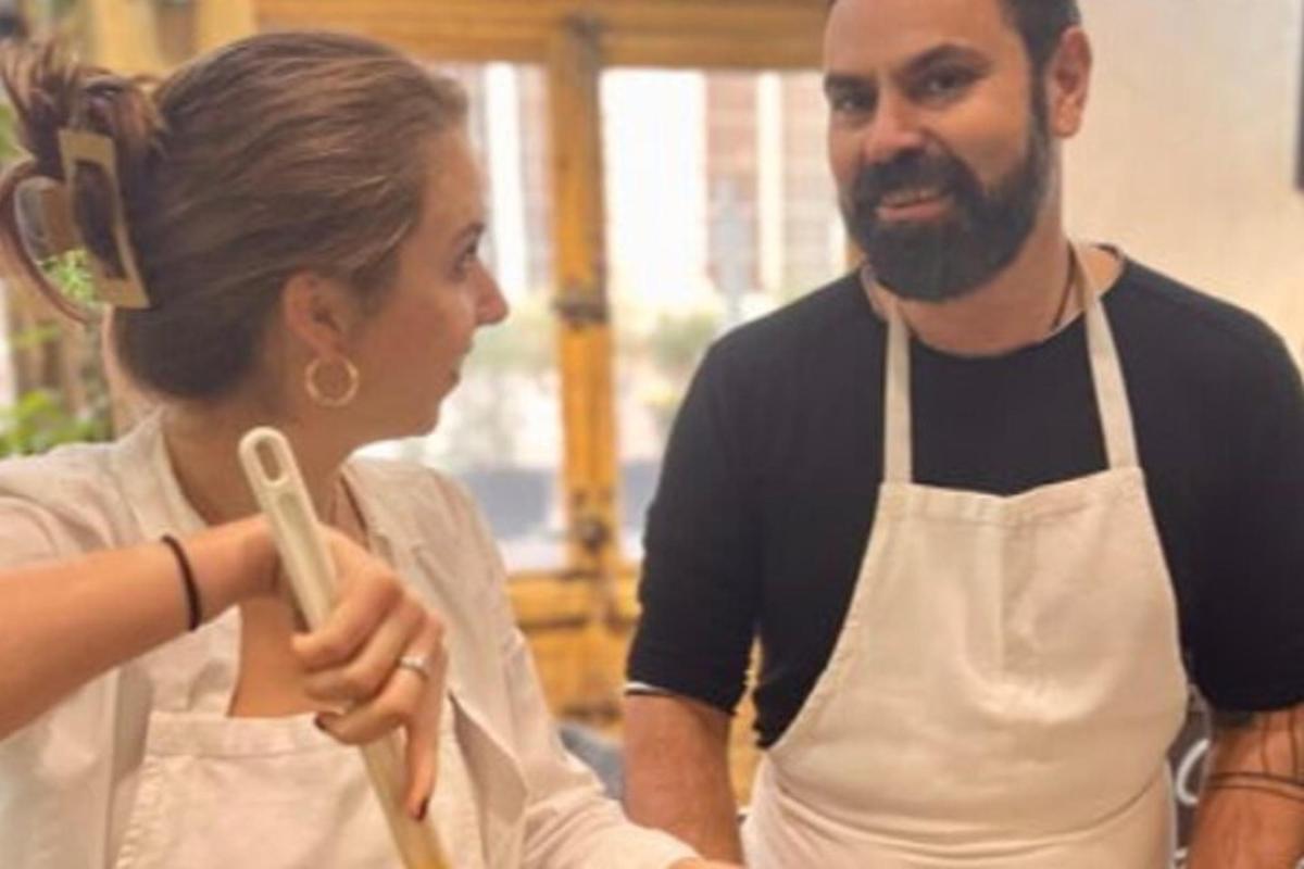 a man and a woman in a kitchen preparing food