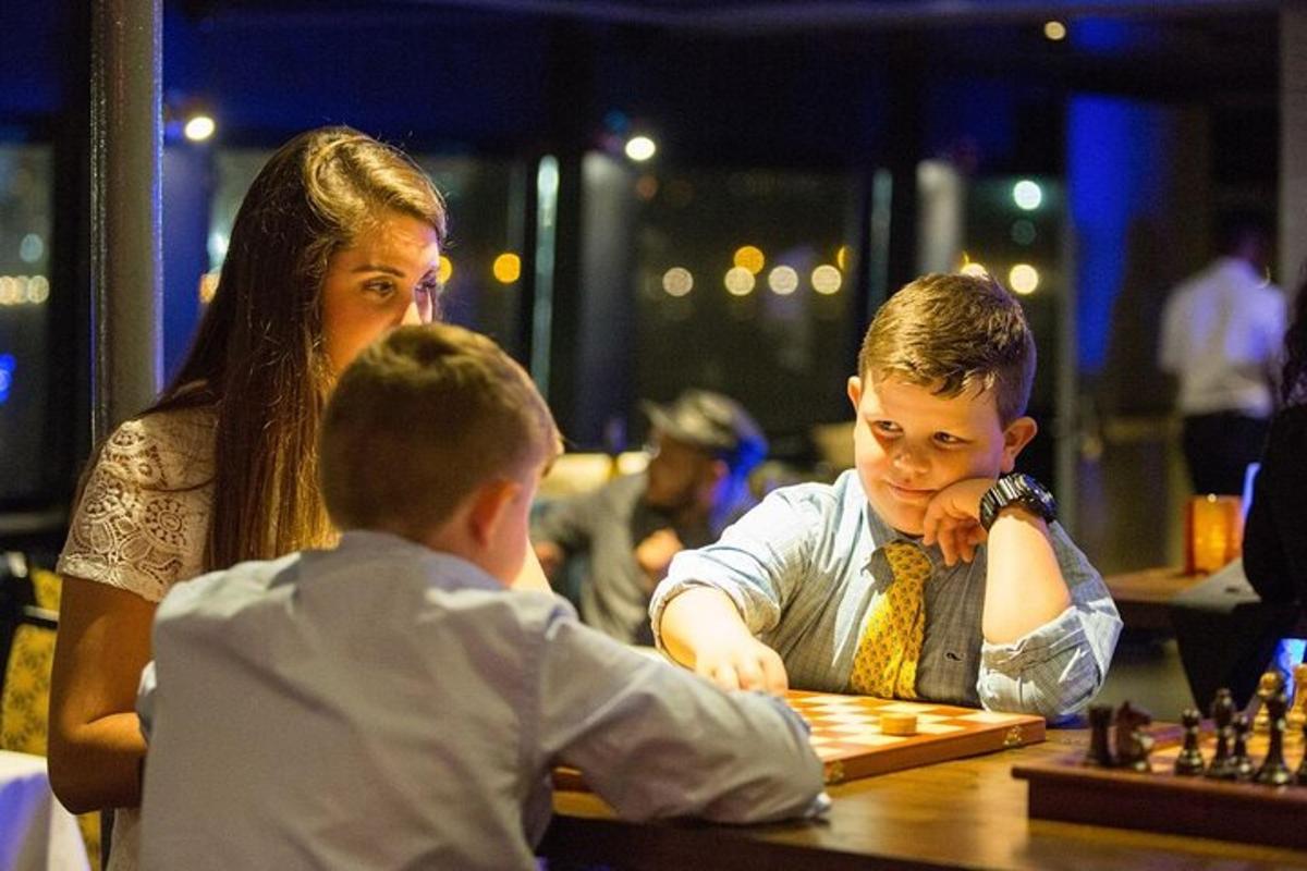 a woman and a boy playing a game of chess